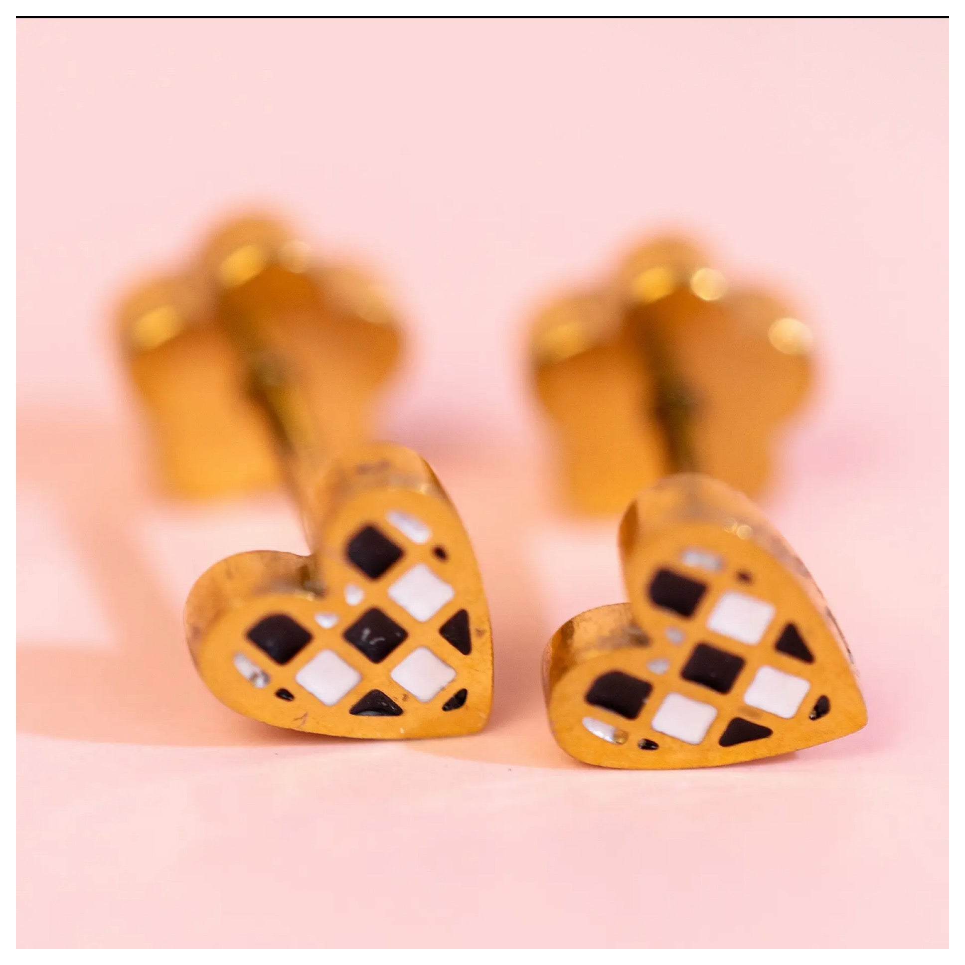 Pierced co black and white checkered heart earrings
