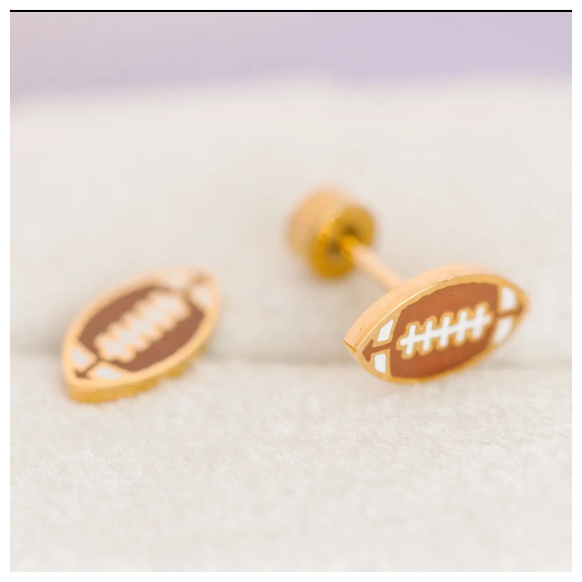 Pierced co football earrings